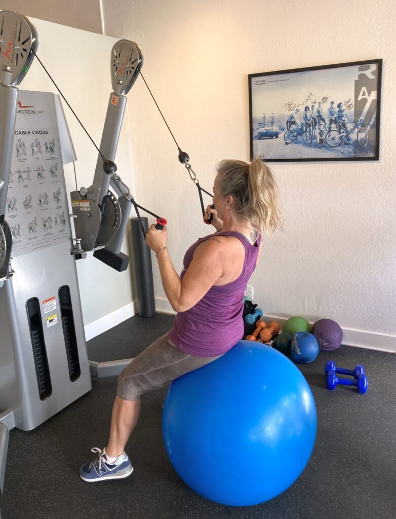 Ellis Fitness Studio - Ashley strengthening lats and back muscles training on freemotion dual cable